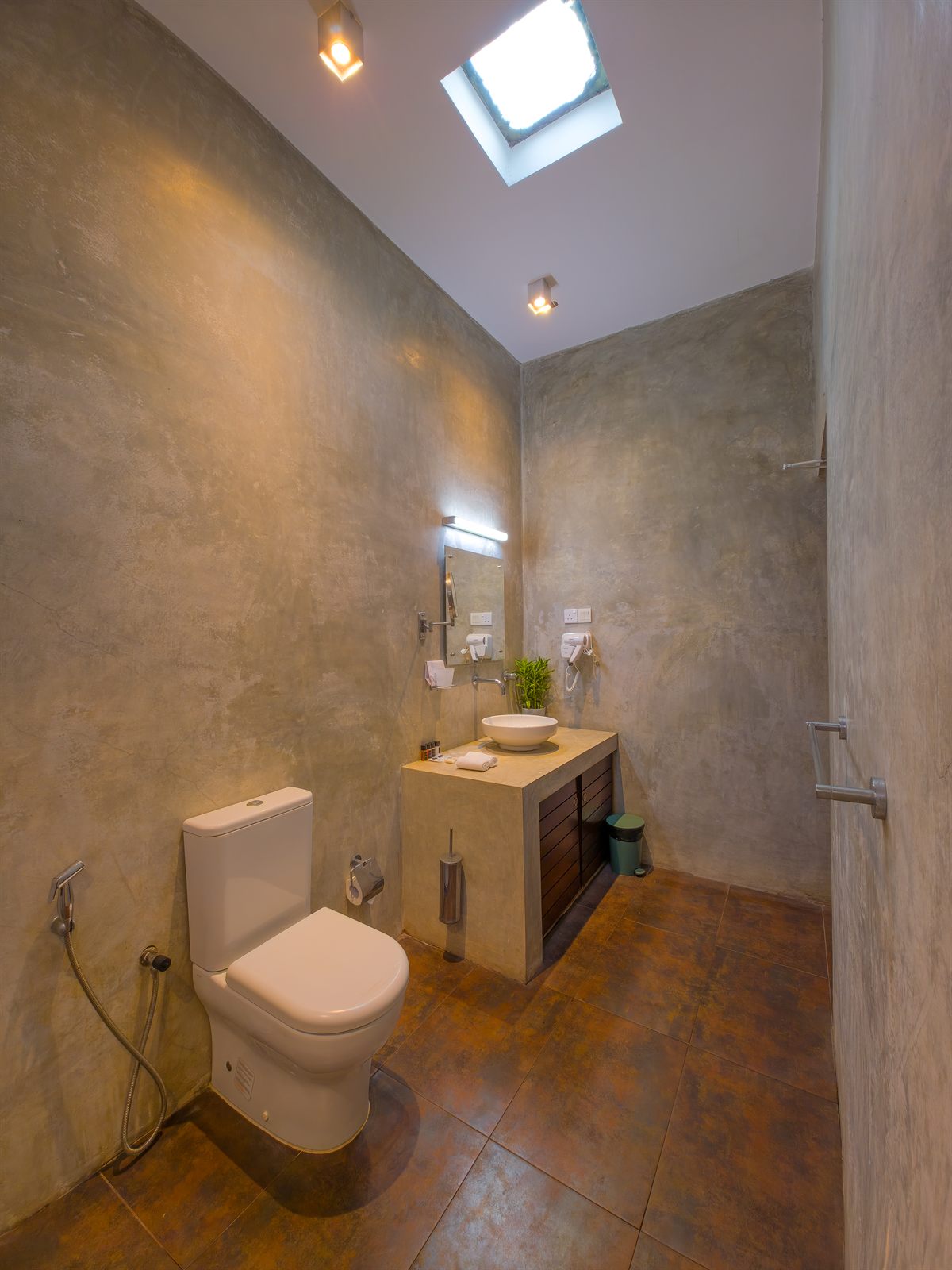 Tall bathroom view with vanity and skylight